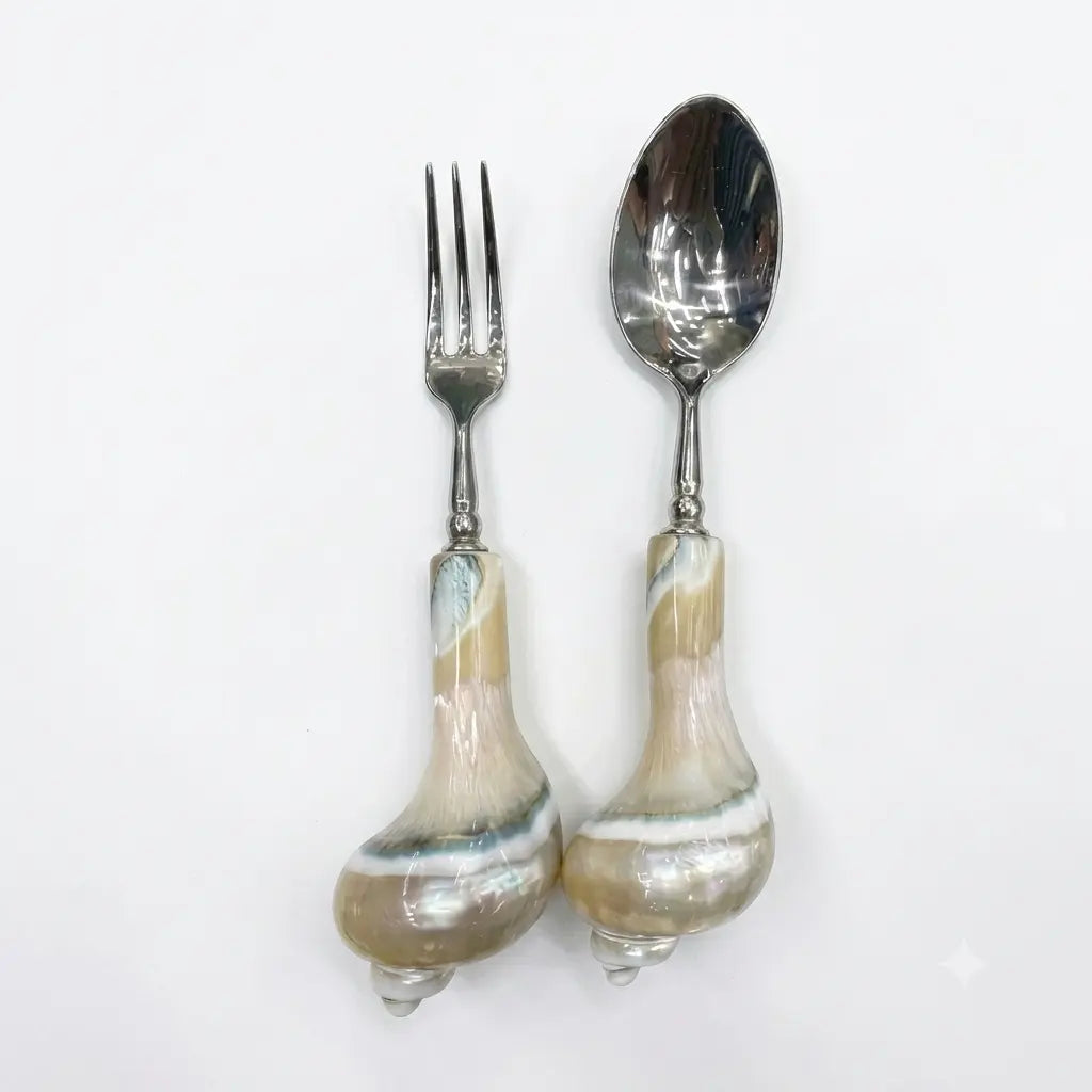 Spoon and fruit fork with decorative conch shell handles and metal heads