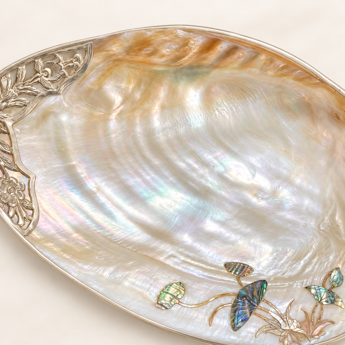 Close-up of natural nacre texture and floral metal edging on a mother-of-pearl tray