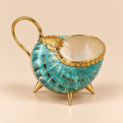 Handcrafted conch shell cup showcasing its natural iridescent shell texture and decorative gold-tone details
