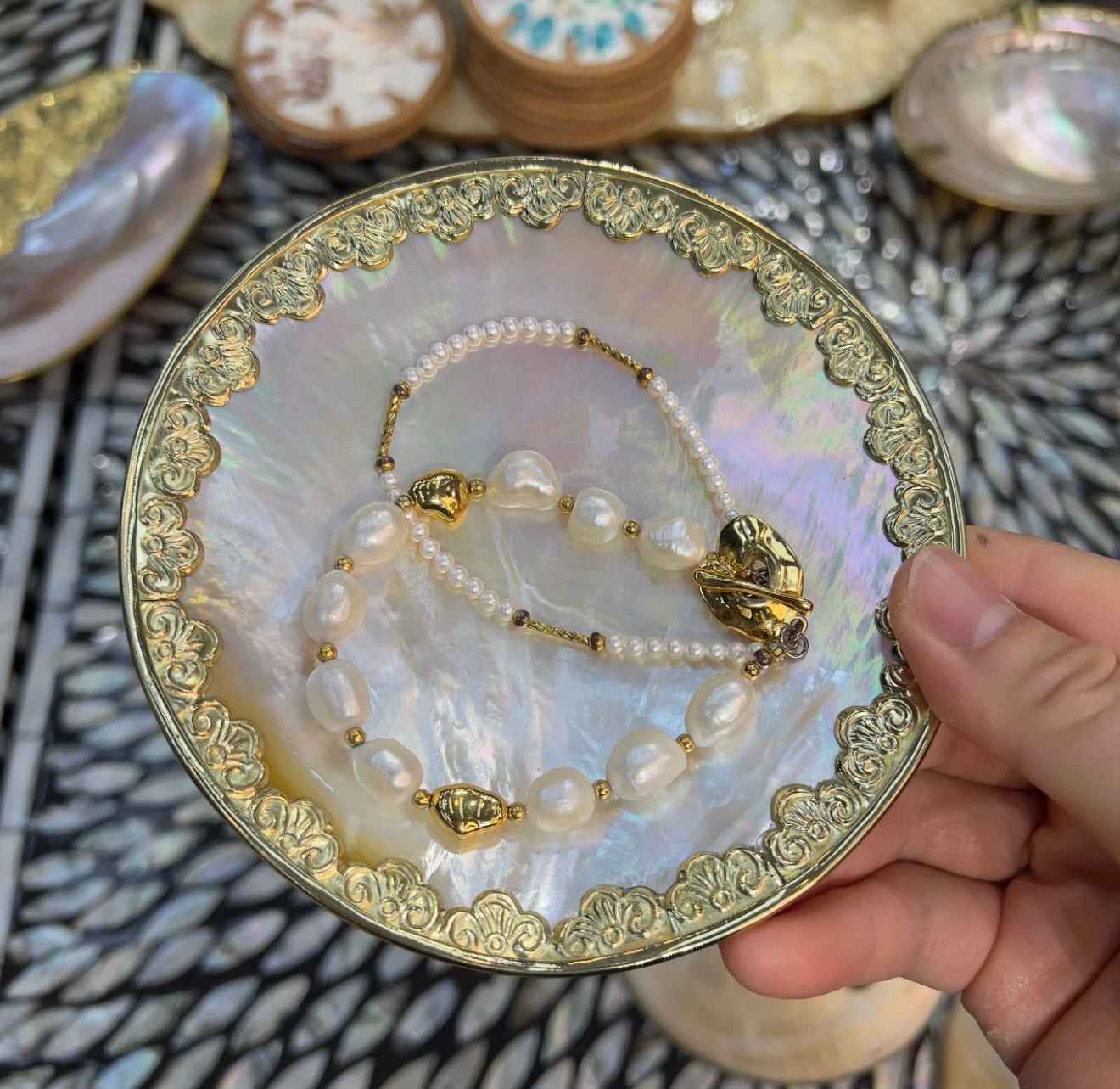 Yellow lip shell dish used as a coastal ring holder and jewelry tray on vanity