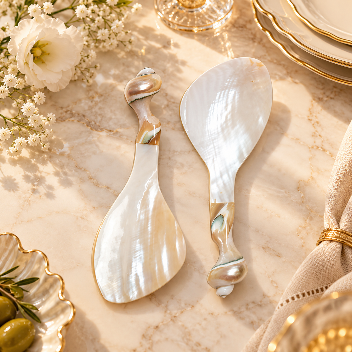 Natural mother of pearl serving spoons on a refined marble tabletop